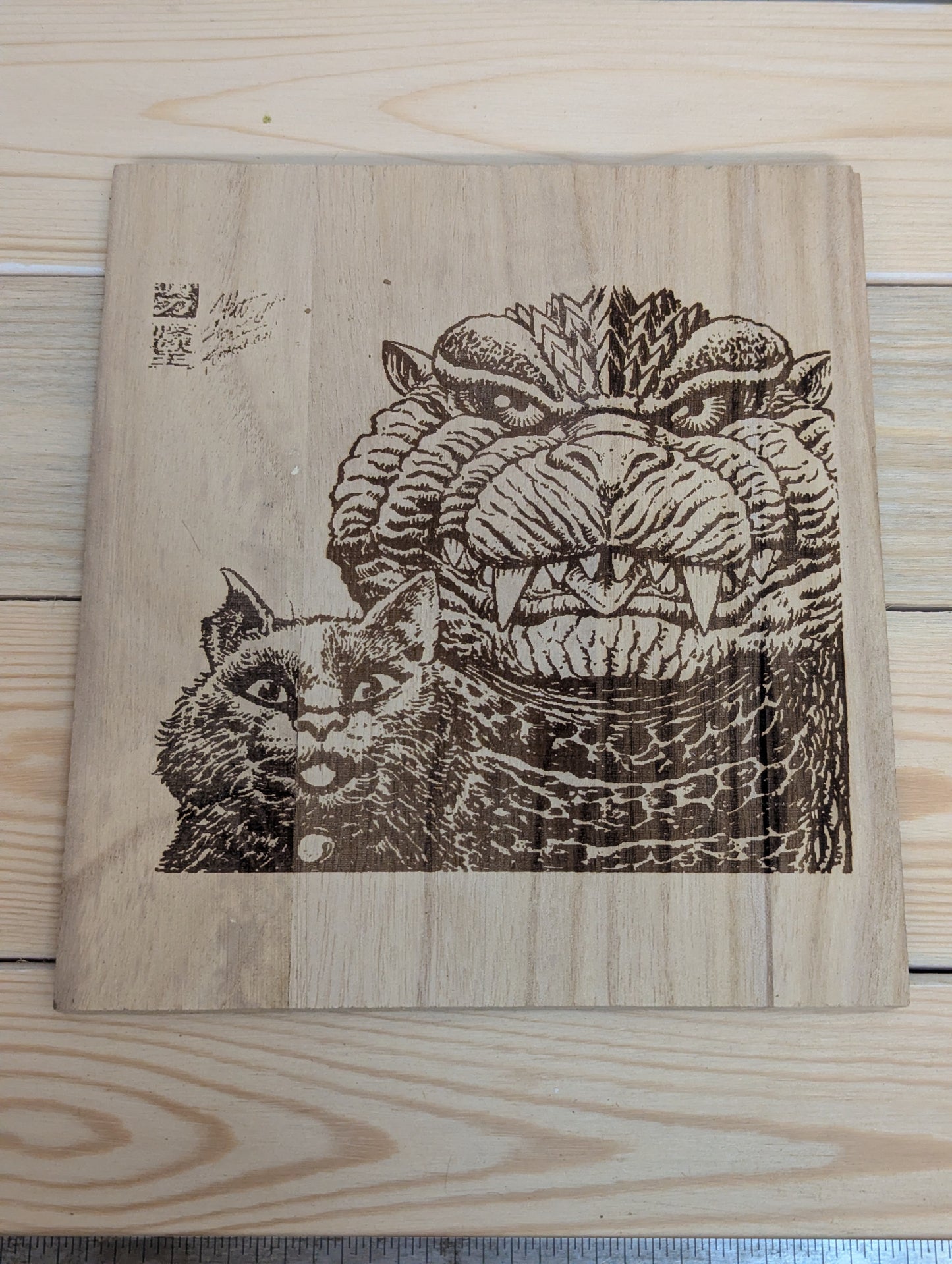 Wood etched cat and Godzilla