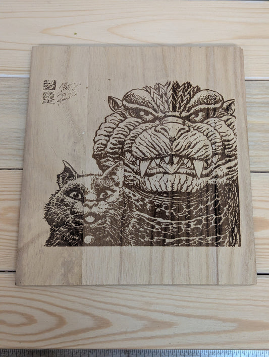 Wood etched cat and Godzilla